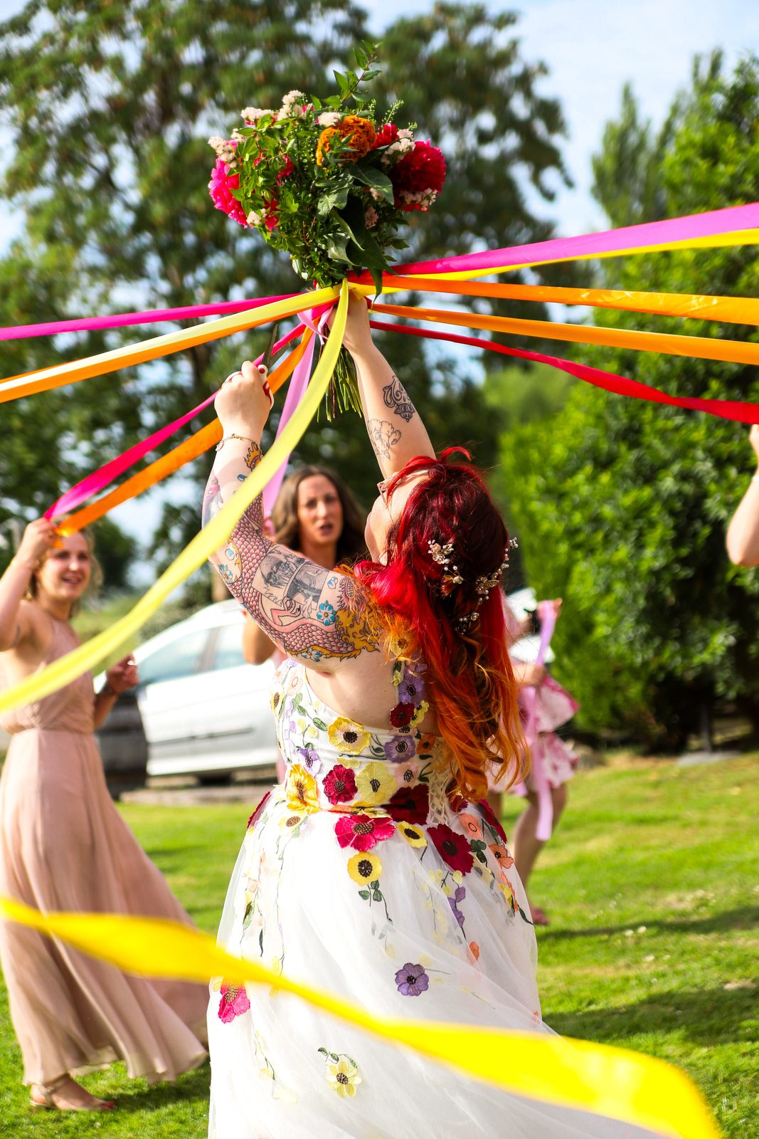Jeu du ruban, la mariée lève son bouquet coloré